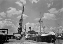 803513 Afbeelding van het overladen van een autolaadkist van de N.S. van een schip naar een vrachtauto in de haven van ...